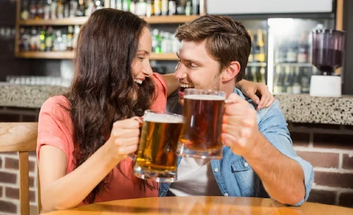 couple toasting beers